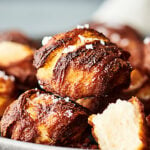 These Homemade Air Fryer Pretzel Bites are made with refrigerated canned biscuit dough, boiled in a water/baking soda solution, and air fried or baked to golden perfection! Don't forget the butter/garlic powder wash and crunchy sea salt! showmetheyummy.com #airfryer #pretzel #homemadepretzelbites #pretzelbites #biscuit