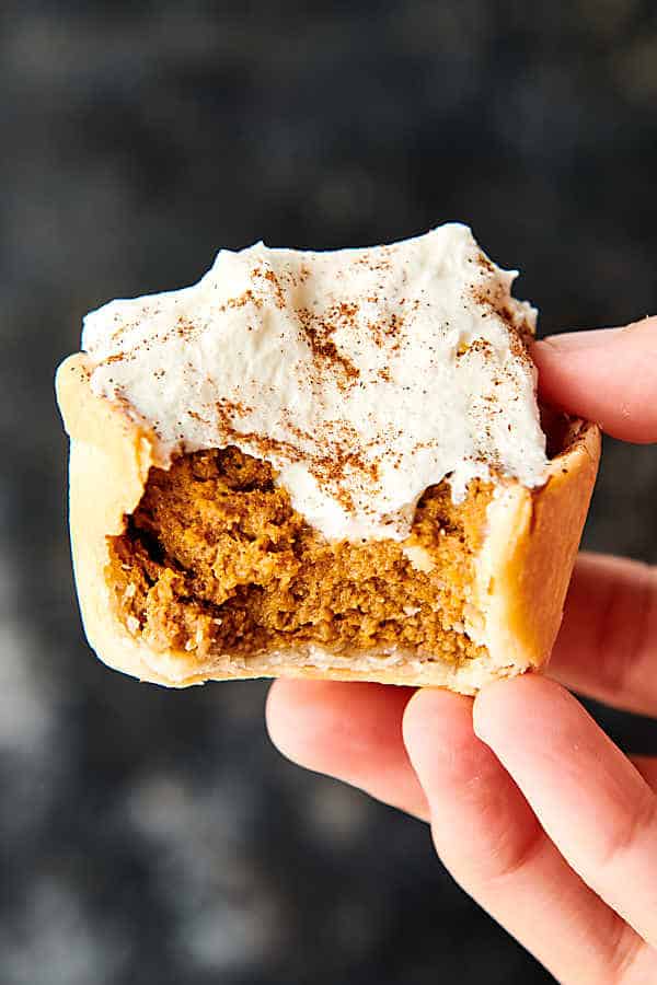 Mini Pumpkin Pies. A classic made in a muffin tin! Store-bought crust (or homemade if you wish) is pressed into a muffin tin and filled with the easiest pumpkin pie filling made with pumpkin purée, condensed milk, eggs, vanilla, and spices: cinnamon, ginger, nutmeg, cloves, and salt! Quick. Easy. Perfectly portioned, so no slicing pie involved! showmetheyummy.com #pumpkin #pie