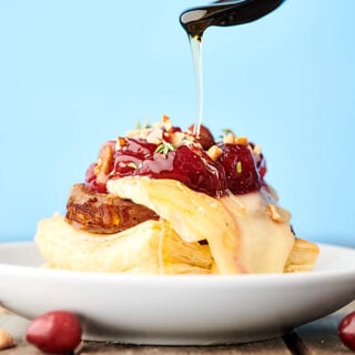 {New!} #ad These Pork and Brie Puff Pastry Bites are perfect for any holiday celebration! Flakey puff pastry is topped with melty brie, tart cranberry sauce, gooey honey, crunchy nuts, and Roasted Garlic & Cracked Black Pepper (or Slow Roasted Golden Rotisserie) Marinated Fresh Pork Tenderloin