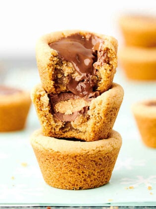 These Easy Peanut Butter Cup Cookies are a holiday classic! Homemade peanut butter cookie dough is baked in a mini muffin tin and stuffed with a Reese's Peanut Butter Cup. YUM. showmetheyummy.com #peanutbuttercupcookie #peanutbuttercup #peanutbutter #cookie #christmascookie