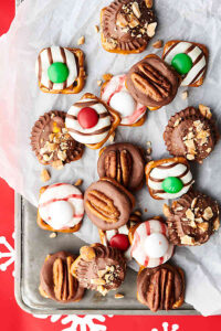 Easy Pretzel Turtles Recipe - 4 Ways. 1. Pretzels with rolos and pecans. 2. Pretzels with peppermint kisses and m&ms. 3. Pretzels with Hershey’s hugs and m&ms. 4. Pretzels with peanut butter cups and honey roasted peanuts. All 3 ingredients, quick, easy, and of course, delicious! showmetheyummy.com #pretzel #turtles #pretzelturtles #candy #caramel #chocolate #peppermint #peanutbutter #whitechocolate #christmascandy