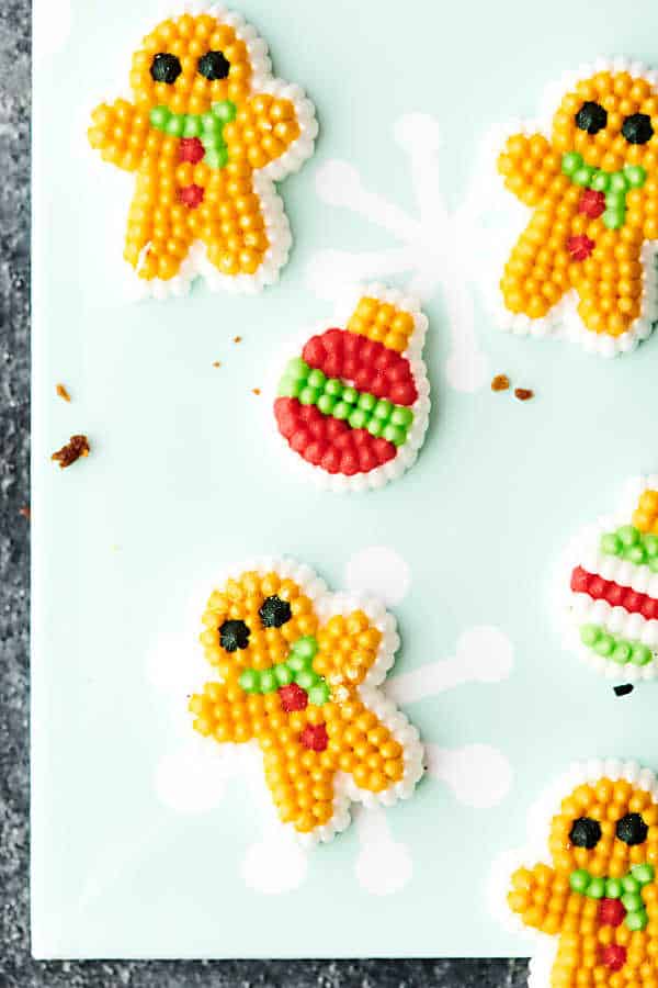 gingerbread men and christmas ornaments candy on tray above