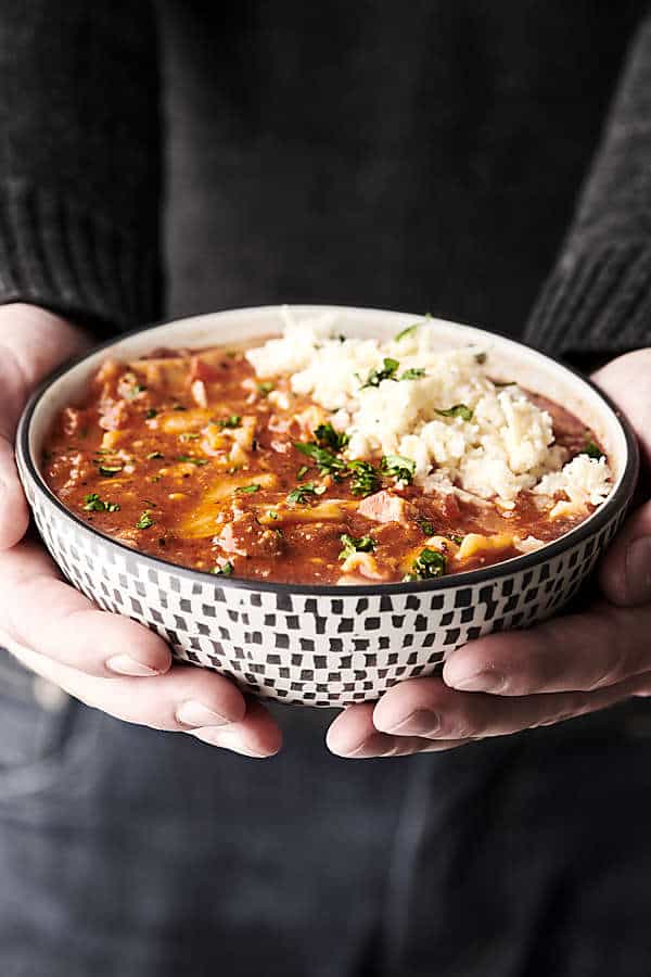 bowl of lasagna soup held two hands