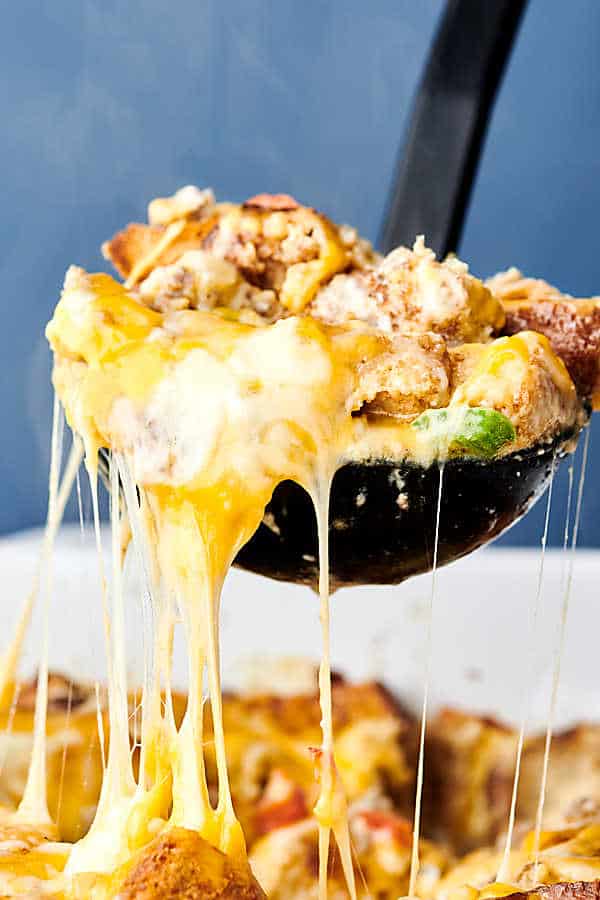 This Overnight Breakfast Sausage Casserole can be prepped and made the night before! Store it in your fridge overnight and bake the next morning. Quick, easy, and loaded with sausage, peppers, onions, toasted bread, eggs, milk, and of course, cheese! showmetheyummy.com #overnightbreakfastcasserole #breakfast #casserole #sausage #eggs #cheese #bread