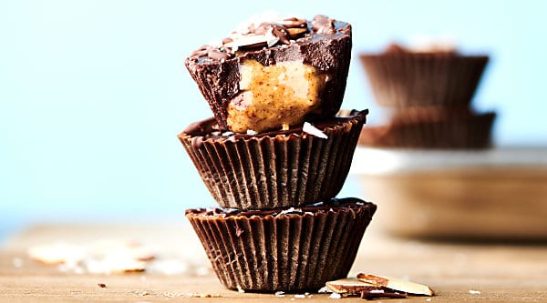 Homemade Almond Butter Cups Recipe. Only 5 ingredients necessary: coconut oil, pure maple syrup, cocoa powder, almond butter, and optional maldon sea salt! Quick. Easy. Healthy. Vegan. Gluten Free! showmetheyummy.com #almondbutter #almondbuttercups #darkchocolate #easyrecipe #healthy #vegan #glutenfree #candy