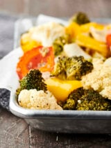 Only 10 ingredients and 30 minutes necessary for this Easy Roasted Vegetables Recipe! Cauliflower, broccoli, onion, peppers, garlic, oil, apple cider vinegar, salt and pepper! Don't like some of those veggies? Just swap them out for your favorites! Only 115 calories. Vegan. Gluten Free. showmetheyummy.com #roastedvegetables #vegan #glutenfree #healthy #recipe