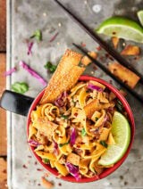 {New!} #ad Egg Roll Noodle Bowl Recipe. Pasta mixed with a flavorful egg roll filling made of pork, onion, spices, coleslaw, soy sauce, seasoned rice vinegar, sesame oil, sriracha, green onions, cilantro, and crispy wonton or egg roll wrapper strips! showmetheyummy.com Made in partnership w/ @noyolksnoodles #DoItWithNoYolks #eggroll #pasta