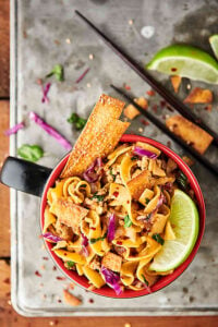 {New!} #ad Egg Roll Noodle Bowl Recipe. Pasta mixed with a flavorful egg roll filling made of pork, onion, spices, coleslaw, soy sauce, seasoned rice vinegar, sesame oil, sriracha, green onions, cilantro, and crispy wonton or egg roll wrapper strips! showmetheyummy.com Made in partnership w/ @noyolksnoodles #DoItWithNoYolks #eggroll #pasta