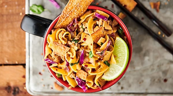 {New!} #ad Egg Roll Noodle Bowl Recipe. Pasta mixed with a flavorful egg roll filling made of pork, onion, spices, coleslaw, soy sauce, seasoned rice vinegar, sesame oil, sriracha, green onions, cilantro, and crispy wonton or egg roll wrapper strips! showmetheyummy.com Made in partnership w/ @noyolksnoodles #DoItWithNoYolks #eggroll #pasta
