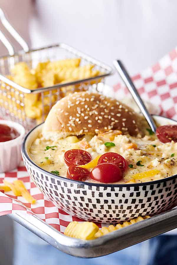 bowl of healthy instant pot cheeseburger soup on tray with fries