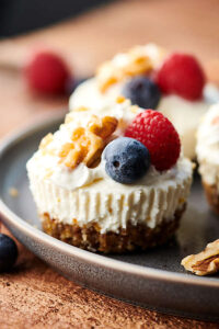 {New!} #ad Healthier Lemon Walnut No Bake Cheesecakes. A naturally sweetened walnut date crust topped with a creamy coconut yogurt, cream cheese, honey, lemon filling! I love this quick and easy recipe with short ingredient list! showmetheyummy.com Made in partnership w/ @cawalnuts #healthy #lemon #walnut #nobake #cheesecake #coconut #glutenfree #vegetarian #dessert #spring