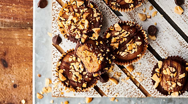 Healthy Date Peanut Butter Cups aka a healthy twist on a classic! These taste like the real deal, but are made with medjool dates, all natural peanut butter, tahini, vanilla, salt, dark chocolate chips, coconut oil, and roasted peanuts for crunch! Vegan. Gluten Free. Quick and easy! showmetheyummy.com #healthy #dates #refinedsugarfree #peanutbutter #naturallysweet #candy #darkchocolate #vegan #homemade #glutenfree #peanutbuttercups