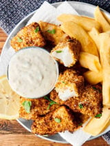 This Homemade Healthy Air Fryer Fish Sticks Recipe only requires 10 ingredients (INCLUDING salt and pepper): cod or tilapia, spices: salt, pepper, paprika, garlic powder, whole wheat flour, eggs, lemon juice, panko breadcrumbs, and old bay seasoning! Oven baked instructions listed as well. showmetheyummy.com #healthy #fishsticks #airfryer #baked