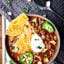 This Instant Pot Chili Recipe is SO quick, easy, and loaded with bacon, beef, beer (optional), broth, tomato sauce, veggies, beans, and spices! Serve with optional, but highly recommended cornbread, shredded cheese, and sour cream! SO hearty and cozy. showmetheyummy.com #instantpot #beef #chili