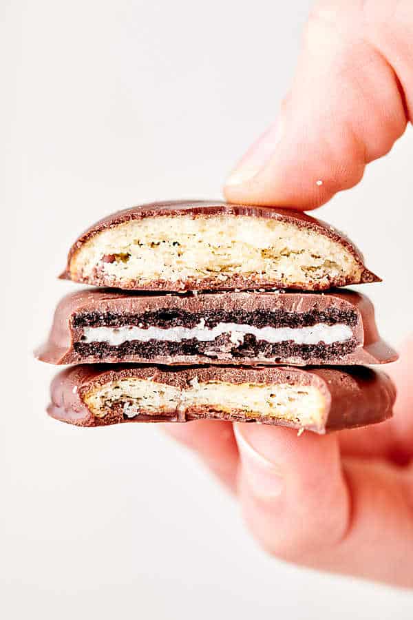 3 thin mint cookies with bites out stacked and held