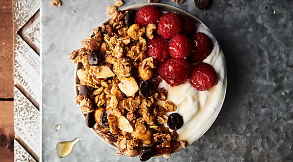 Almond Butter Granola. A healthy, can be gluten free and vegan recipe made with crunchy almond butter, coconut oil, honey (or agave), maple syrup, oats, almonds, dark chocolate chips, and more! Quick. Easy. Delicious! showmetheyummy.com #almondbutter #granola #healthy #glutenfree #vegan #snack #chocolate