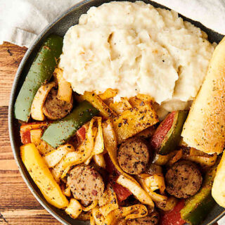 Sheet Pan Chicken Sausage and Peppers. One dirty dish, need I say more? ;) Loaded with chicken sausage, onions, peppers, and spices, this recipe is ready in under 30 minutes and packed with flavor and healthy deliciousness! Less than 250 calories per serving. showmetheyummy.com #chicken #sausage #peppers #sheetpan #onepot #dinner #kidfriendly #recipe #familydinner #healthy #glutenfree