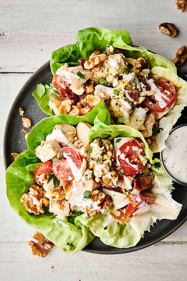 two walnut cobb salad lettuce wraps on plate above