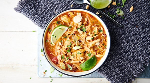 Coconut Curry Chicken Noodle Soup Recipe. Quick, easy, healthy, gluten free, and dairy free! Loaded with veggies, spices, peanut butter, red curry paste, a touch of brown sugar, broth, lite coconut milk, fish sauce, chicken, lime juice, rice noodles, fresh herbs, and peanuts! showmetheyummy.com #coconut #curry #chicken #noodle #soup #thai #healthy #recipe