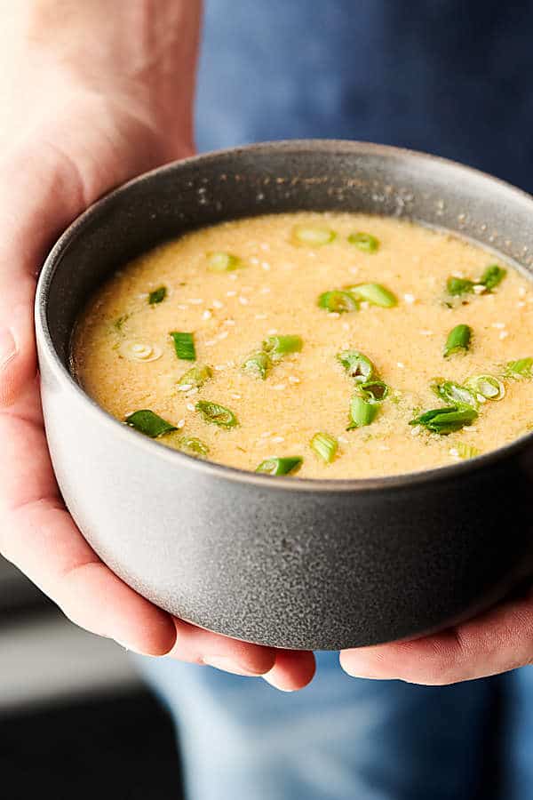 egg drop soup bowl held two hands