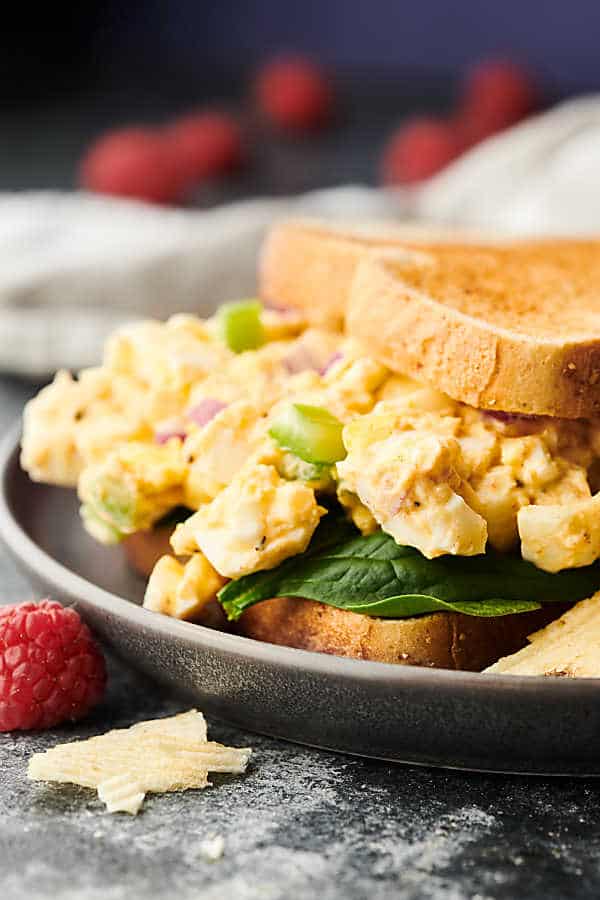 egg salad sandwich on plate side view