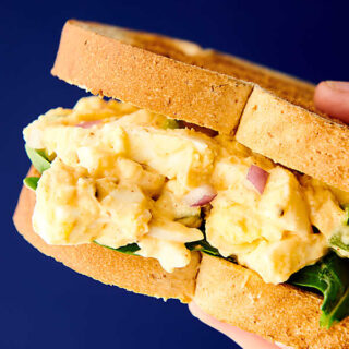 This Easy Egg Salad Recipe is great for a quick and easy, healthy, gluten free, vegetarian, low carb, meal prep lunch! Hard boiled eggs with celery, red onion, light mayo, non fat plain greek yogurt, dijon, and spices! Less than 150 calories per serving! showmetheyummy.com #eggsalad #sandwich #lowcarb #glutenfree #vegetarian #healthy #protein