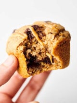 These Healthy Banana Pancake Muffins are loaded with bananas, pure maple syrup, all natural peanut butter, fat free buttermilk, egg, vanilla extract, whole grain protein pancake mix, cinnamon, and dark chocolate chunks! Quick, healthy, and delicious! Freezer friendly. Less than 250 calories per muffin! showmetheyummy.com #healthy #banana #pancake #muffins #chocolate