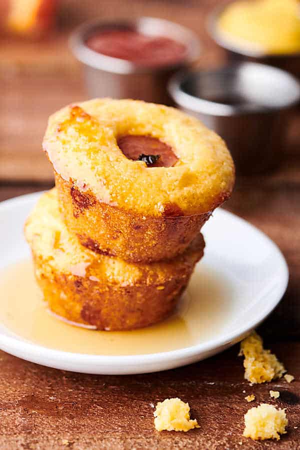 two jalapeno cheddar corn muffins stacked on plate