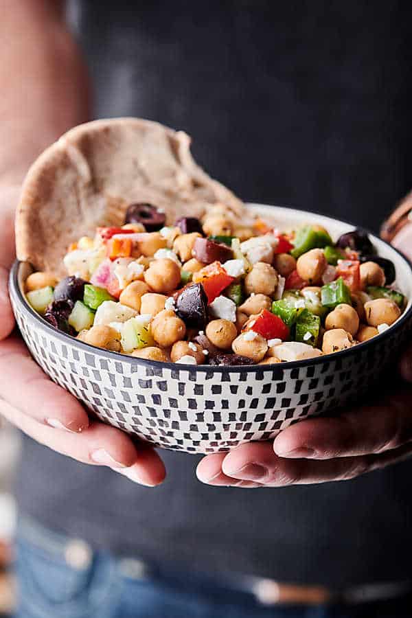 bowl of Mediterranean chickpea egg salad held