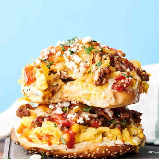 Sausage, Egg, and Cheese Breakfast Pizza Bagels Recipe. Everything bagels smothered in cream cheese and loaded with breakfast sausage, onion, bell peppers, fluffy scrambled eggs, mozzarella, and cheddar cheese. showmetheyummy.com #breakfast #pizza #bagels #sausage #eggs #cheese