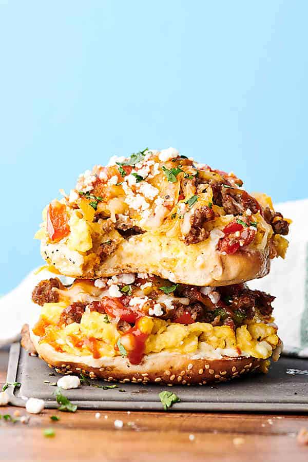 Sausage, Egg, and Cheese Breakfast Pizza Bagels Recipe. Everything bagels smothered in cream cheese and loaded with breakfast sausage, onion, bell peppers, fluffy scrambled eggs, mozzarella, and cheddar cheese. showmetheyummy.com #breakfast #pizza #bagels #sausage #eggs #cheese