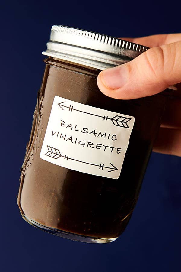 balsamic vinaigrette holding in hand
