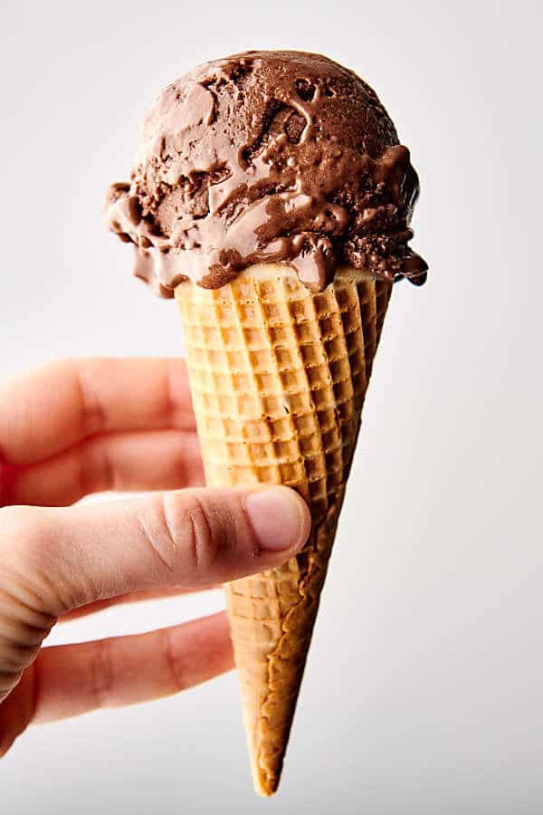 healthy chocolate peanut butter banana ice cream cone held