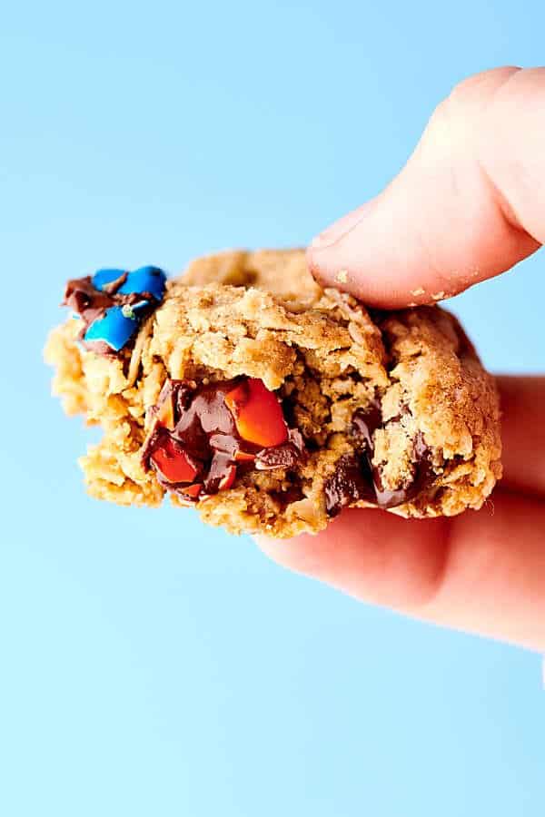 Partially eaten monster cookie in hand