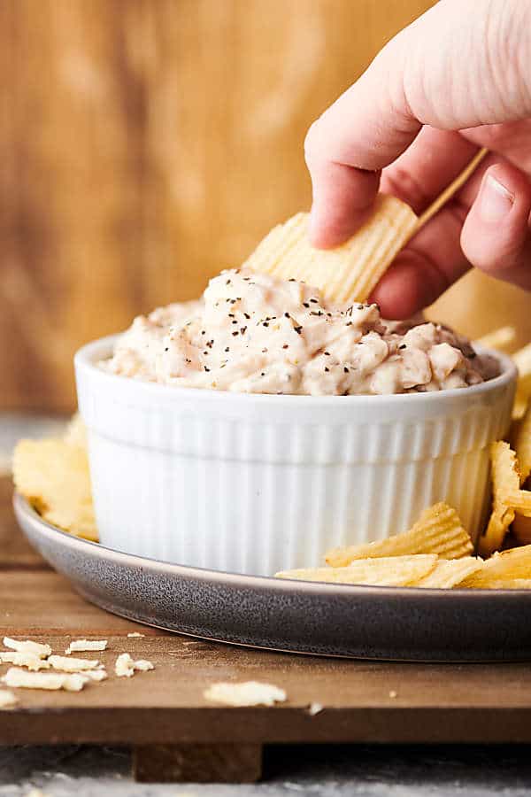 dipping chip into french onion dip