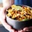 mexican street corn pasta salad holding in hands