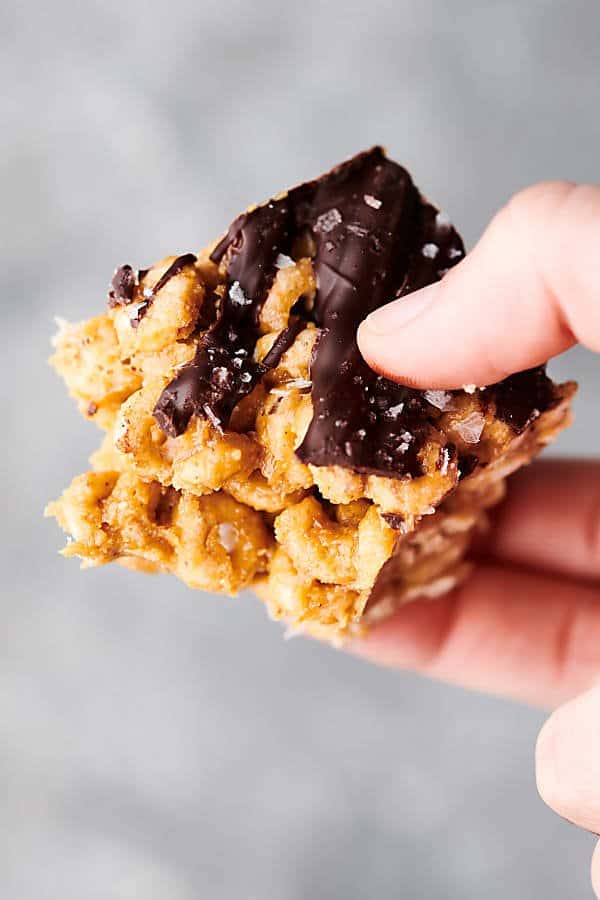 healthy peanut butter honey cheerio bars holding in hand