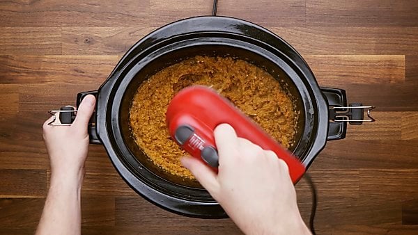 hand mixer being used to mix sweet potato casserole ingredients