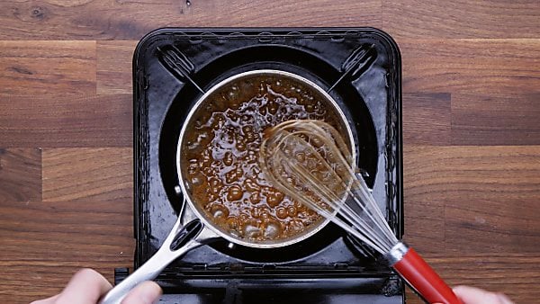 sugar mixture for mini pecan pies in saucepan