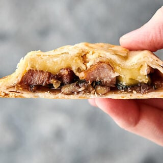 Pork, Brie, and Fig Hand Pies holding in hand