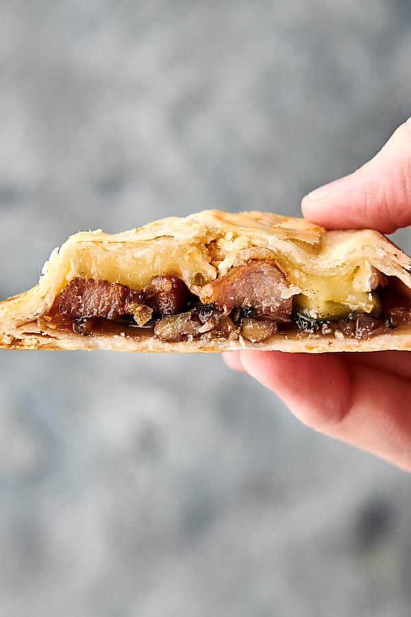 Pork, Brie, and Fig Hand Pies holding in hand