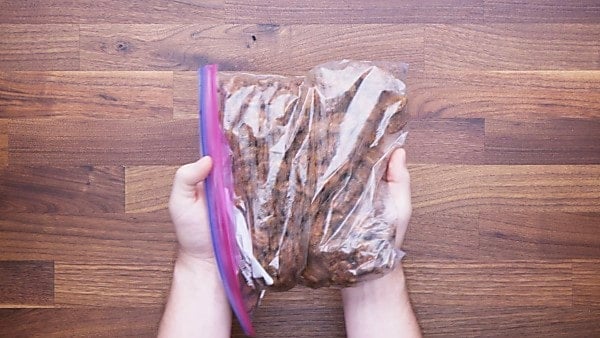 Pecans mixed with sugar and spices in ziplock bag