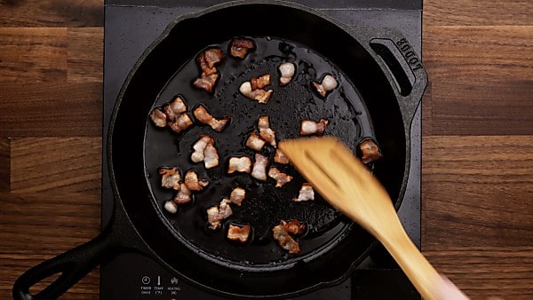 Bacon being cooked in skillet
