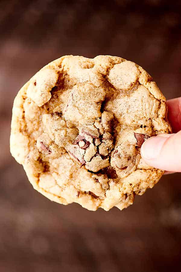 chewy chocolate chip cookies holding in hand