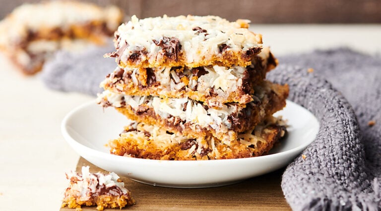 Magic Cookie Bars stacked on plate horizontal