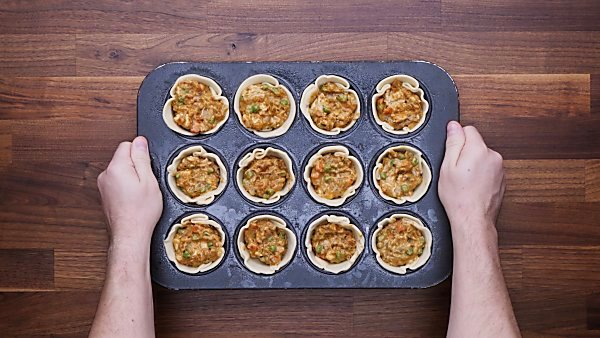 Mini chicken pot pies in muffin tin unbaked