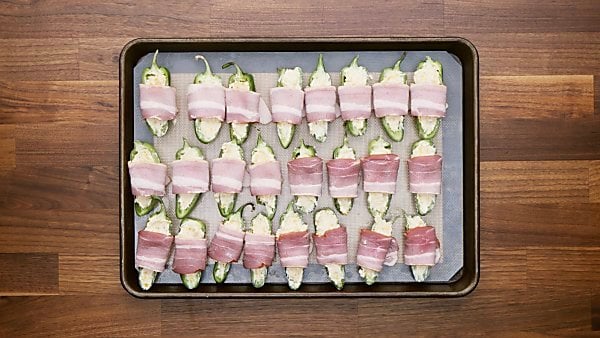 Uncooked bacon wrapped jalapeno poppers