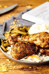 Air fryer fried chicken on a plate with green beans and potatoes
