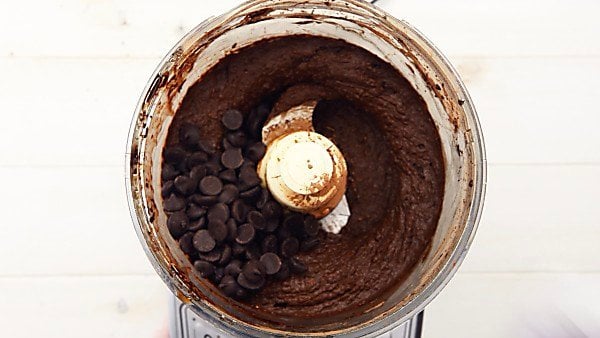 blended black bean brownie batter in food processor with chocolate chips