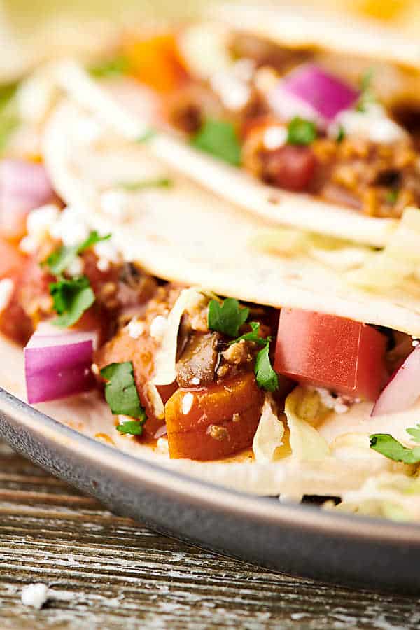 Closeup of instant pot turkey taco on plate with another taco in the background blurred